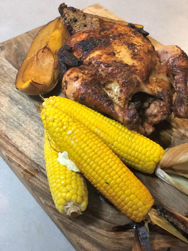 Kamado Joe Joetisserie Chicken with corn and pumpkin.